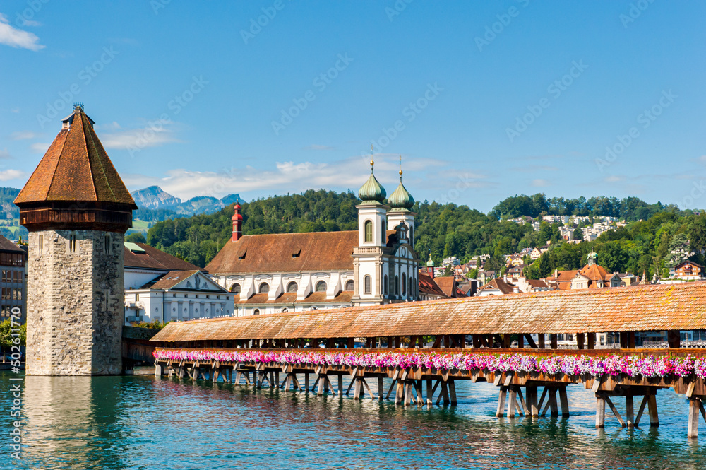 The Roman Catholic Jesuit Church, water tower and the Chapel Bridge in Lucerne in Switzerland 