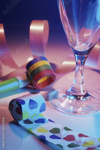 Close-up of party favors near an empty glass photo