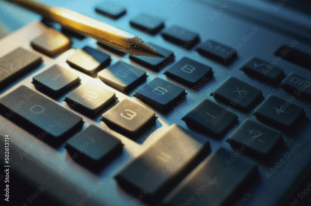 Close-up of a pencil on a calculator Close-up of a pencil on a calculator