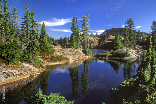 Reflection of trees in a lake, Rampart Lakes, Washington State, USA photo