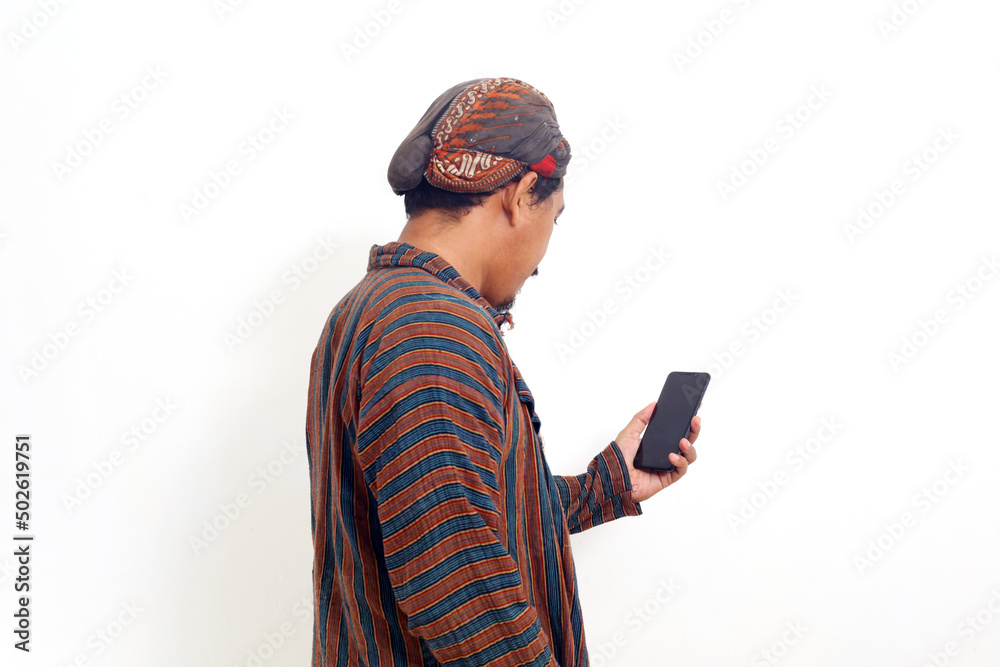 Back view of asian man standing while holding a cell phone. Isolated on white background Back view of asian man standing while holding a cell phone. Isolated on white background