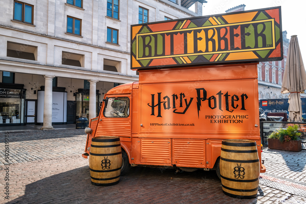 Fototapeta premium Orange food and drink truck selling Butterbeer, in Covent Garden, London. This drink was make famous and popular by the Harry Potter film franchise.