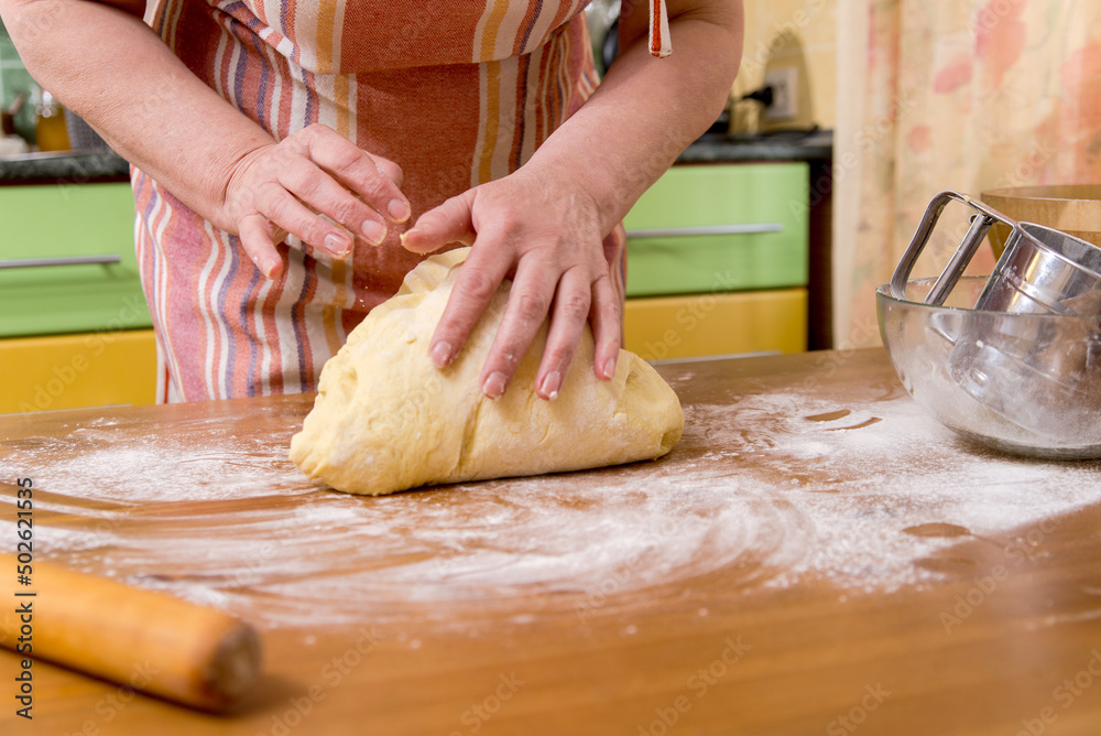 woman's hands knead the dough make bread, pasta or pizza.