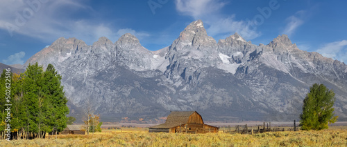 Historic Mormon barn in front of Teton mountain range in Grand Teton national park. photo