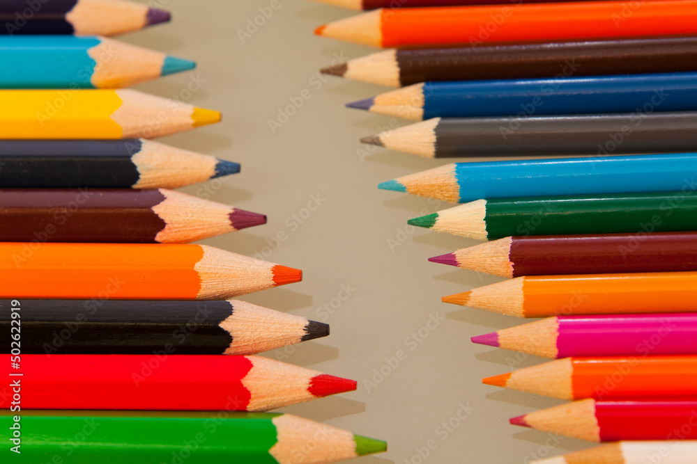 Row of colored pencils with sharp points