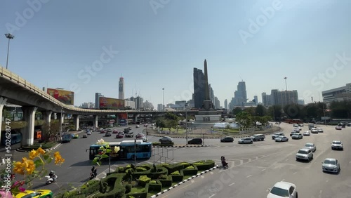 Victory monument, known as Anusawari Chai Samoraphum panoramic view sunny day. Roundabout traffic vehicles on road, blue sky cityscape  photo