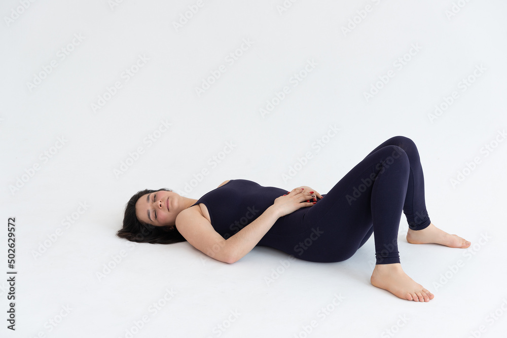 Sporty young woman doing yoga practice isolated on white background. Concept of healthy life and natural balance between body and mental development. Full length Sporty young woman doing yoga practice isolated on white background. Concept of healthy life and natural balance between body and mental development. Full length