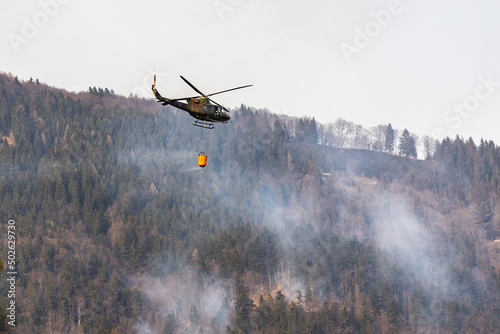 helicopter in flight putting out fire photo