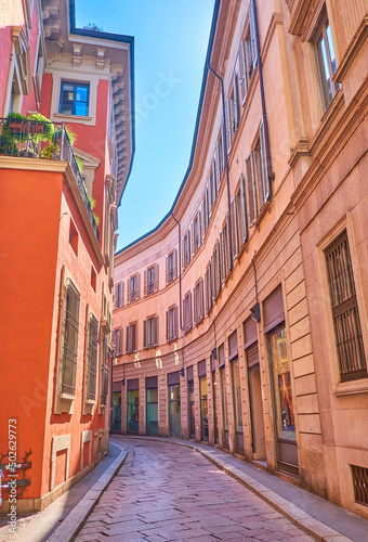 The narrow curved street Via Gerolamo Morone in central Milan, Italy photo