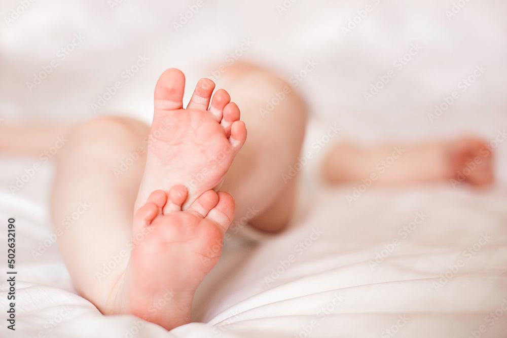 Tiny little baby feet. Adorable baby fingers. Cute infant closeup Tiny little baby feet. Adorable baby fingers. Cute infant closeup