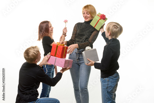 Children give a gift to mom, boys give a gift in boxes, flower girl