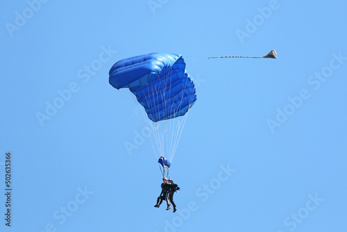 Tandem Skydiver flying wing in a blue sky 