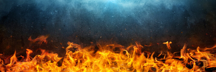 Flame, fire on the background. black walls and smoke. Wide background on the theme of fire, elements, horror, hell, Halloween, etc.