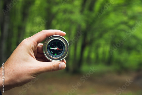 Obraz na płótnie Compass in man hand in forest