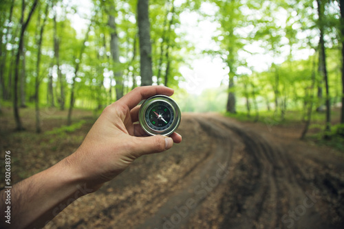 Obraz na płótnie Compass in man hand in forest
