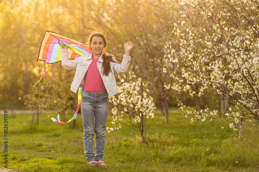 Obraz premium happy child girl with a kite running on meadow in nature.