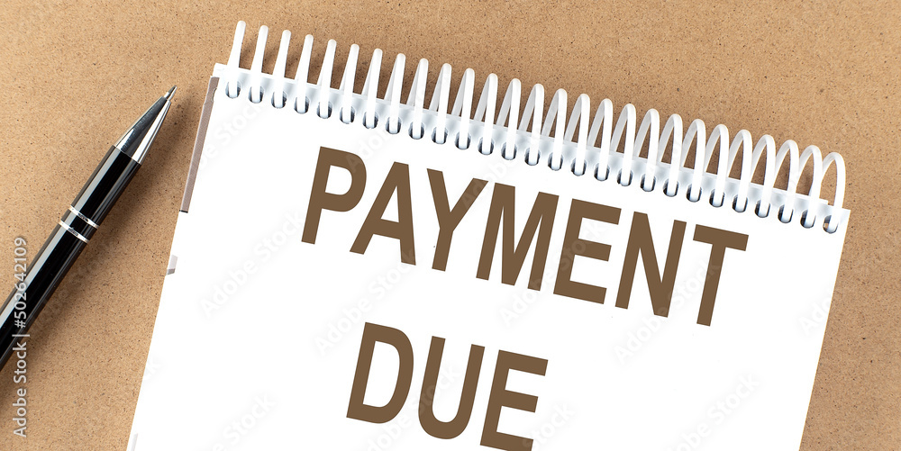 PAYMENT DUE text on a notepad with pen, business concept PAYMENT DUE text on a notepad with pen, business concept
