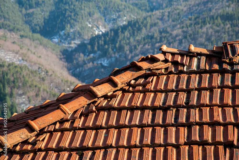 Old rural country house ceramic tiled top roof closeup