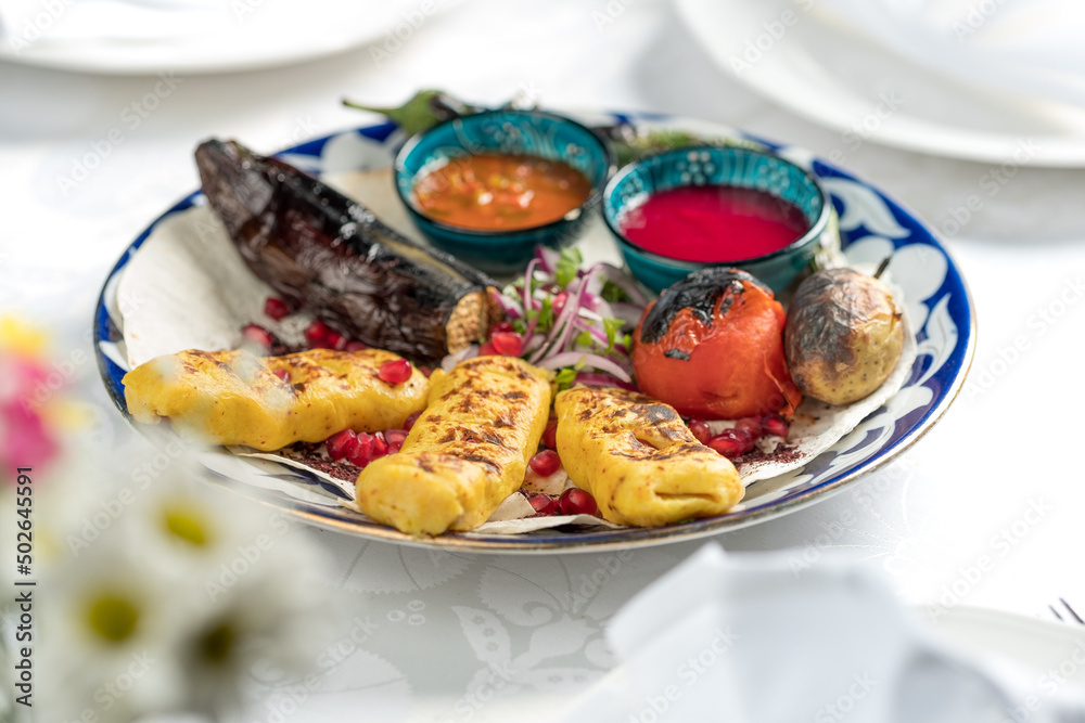 Grilled vegetables on a plate, Ukrainian cuisine. Photo of food on a white background