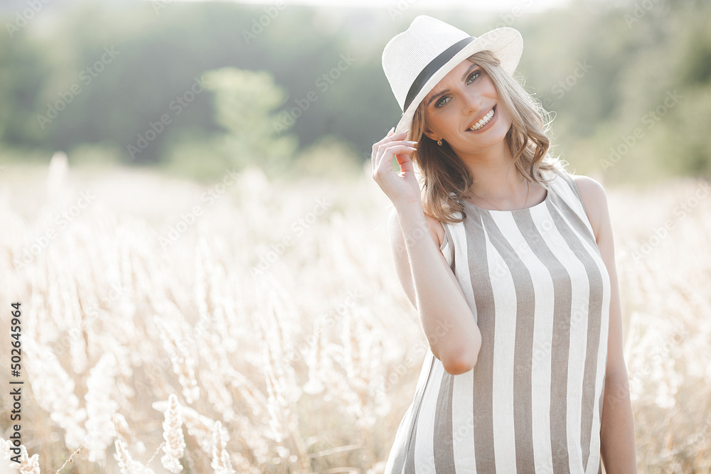 Young attractive woman in the hat. Closeup portrait of beautiful woman outdoors. Pretty lady smiling