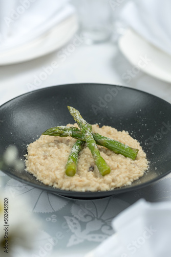 Porridge with asparagus on a plate, Ukrainian cuisine. Photo of food on a white background