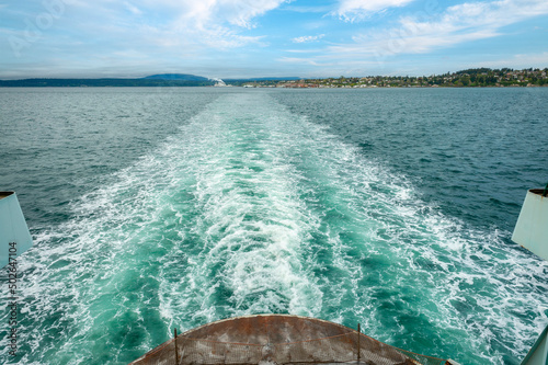 Ferry Boat Leaving the Historic Town of Port Townsend, Washington.  A Washington State Ferry leaves a wake as the city of Port Townsend recedes in the background. photo