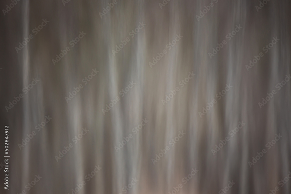 Obraz premium Abstract blurred background. Reflection of tree trunks in the river. Creative photo. Brown gray abstract background.