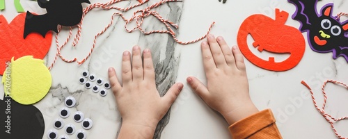 Children siblings sister and brother making decorations for Halloween party celebration. Do it yourself, diy, creativity, holiday concept. Banner.