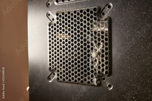 Dust contamination of the computer case grille. PC care and cleaning.