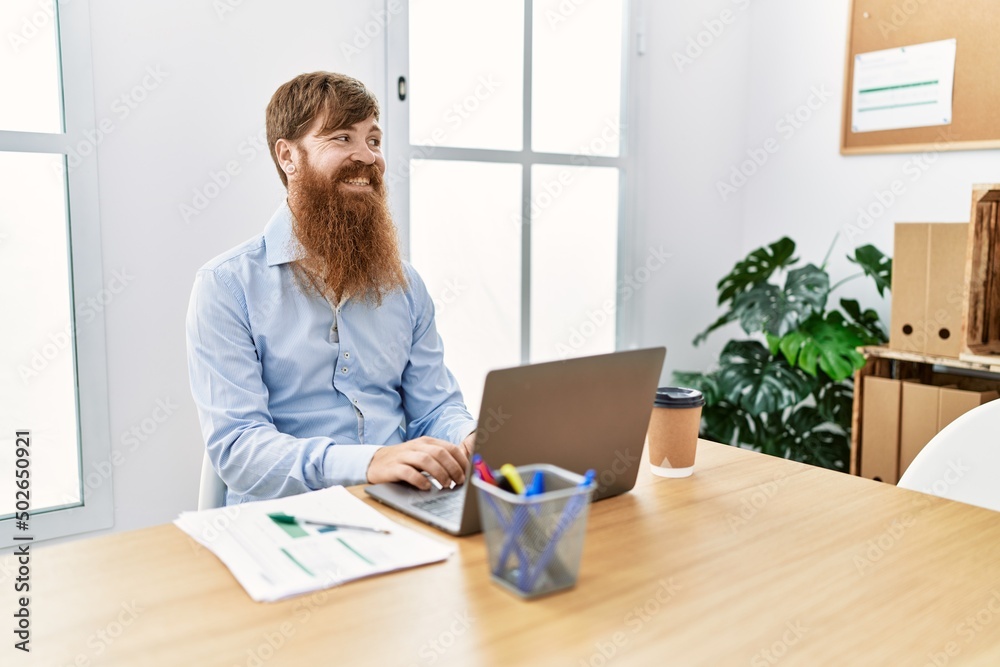 Young irish businessman smiling happy working at the office. Young irish businessman smiling happy working at the office.