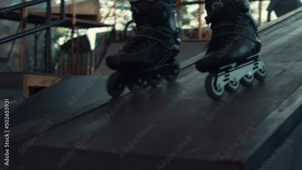 Active boy rollerblading at urban skate park for leisure. Rider roller skating.