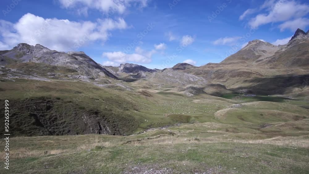 Wide panoramic shot of a mountain landscape with herd of sheep in the Pyrenees, France Wide panoramic shot of a mountain landscape with herd of sheep in the Pyrenees, France