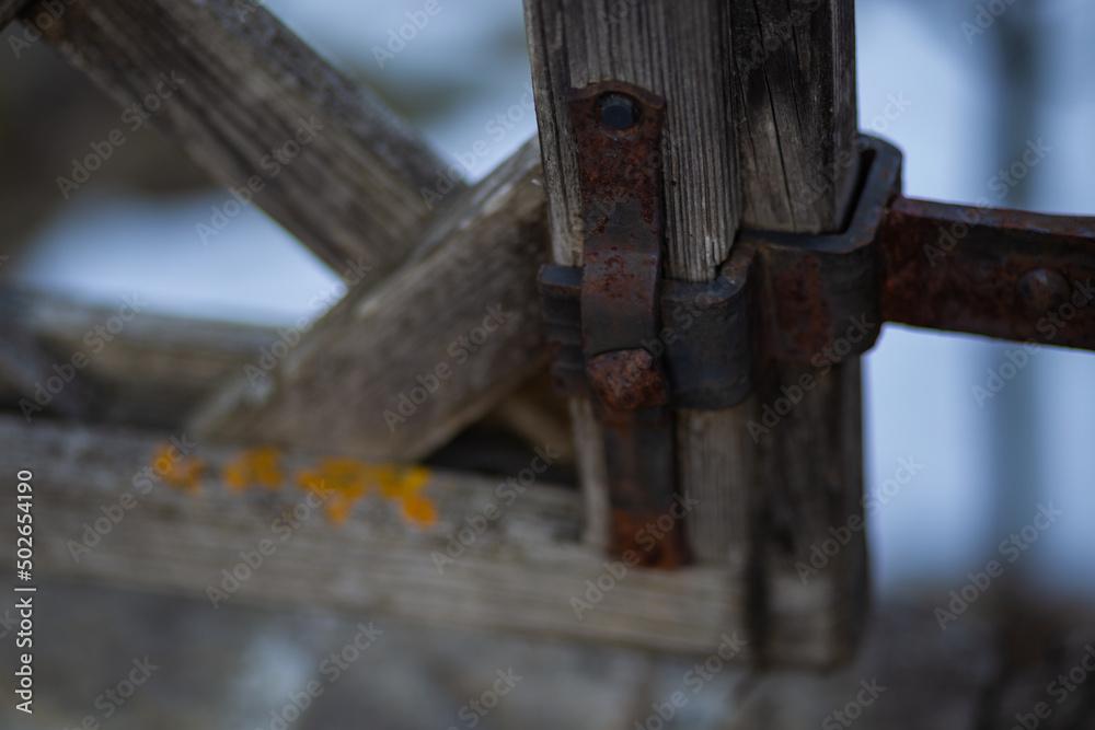 old rusty wrought iron locks and trim forged by a blacksmith on an old wooden gate