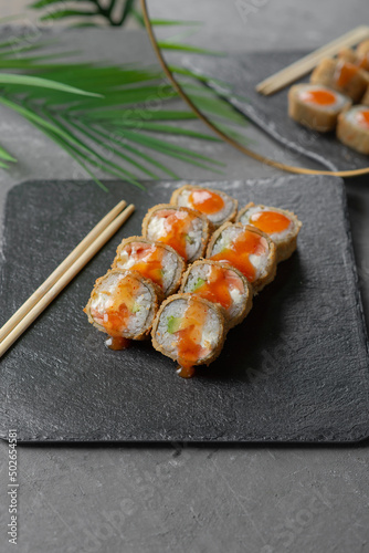 Hot tempura sushi on a gray dish close-up
