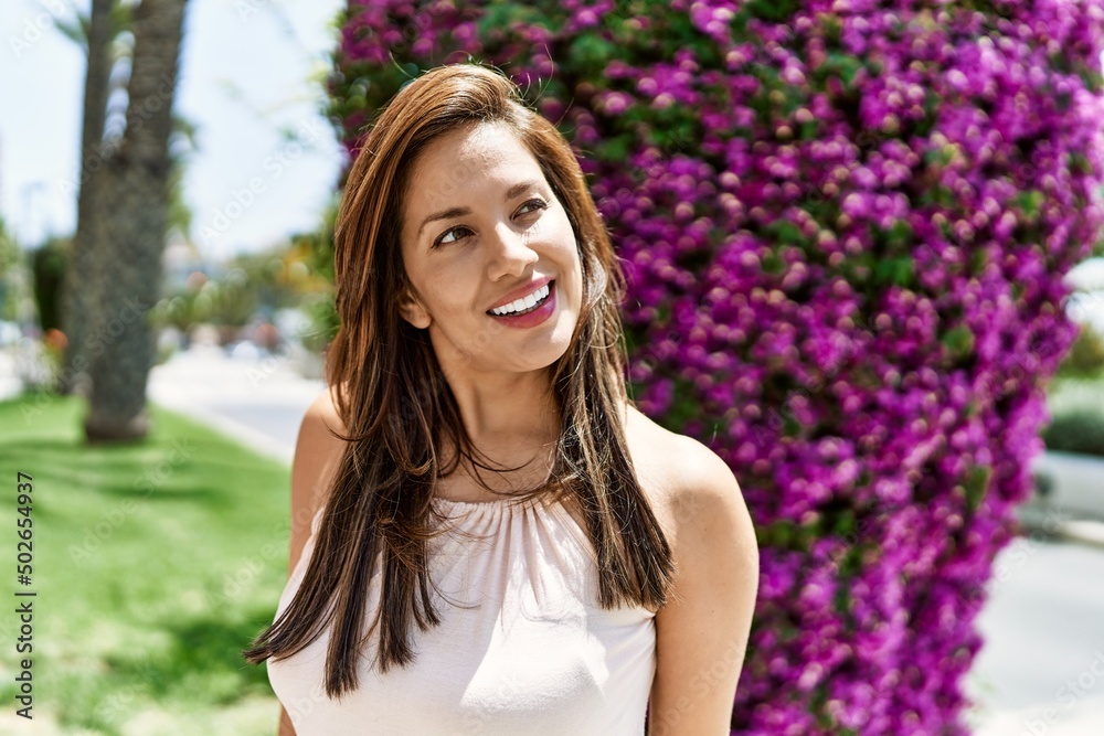Hispanic beautiful woman standing outdoors smiling happy on a sunny day Hispanic beautiful woman standing outdoors smiling happy on a sunny day
