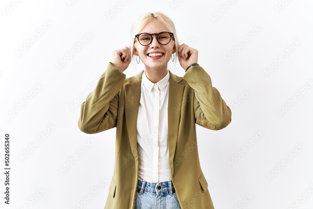 Beautiful caucasian business woman standing over isolated background smiling pulling ears with fingers, funny gesture. audition problem Beautiful caucasian business woman standing over isolated background smiling pulling ears with fingers, funny gesture. audition problem