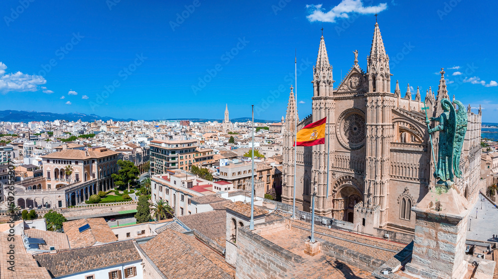 Aerial view of the Spanish flag near the La Seu, the gothic medieval cathedral of Palma de Mallorca in Spain