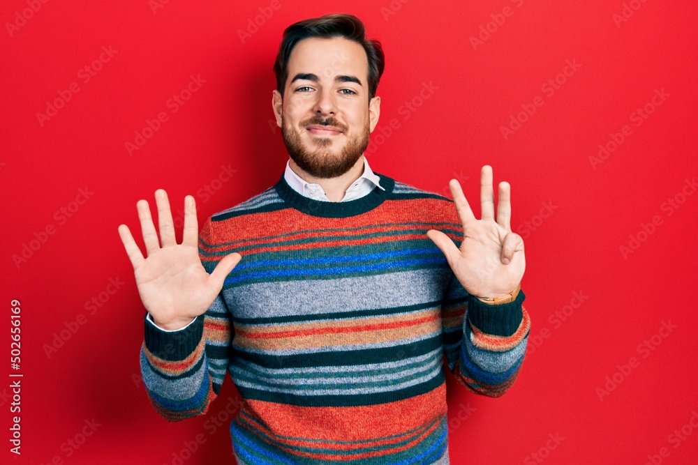 Naklejka premium Handsome caucasian man with beard wearing elegant wool winter sweater showing and pointing up with fingers number nine while smiling confident and happy.