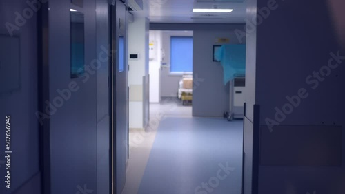 Interiors of modern medical clinic hallway with no people. Wide shot hospital corridor indoors. Medicine and health care concept photo