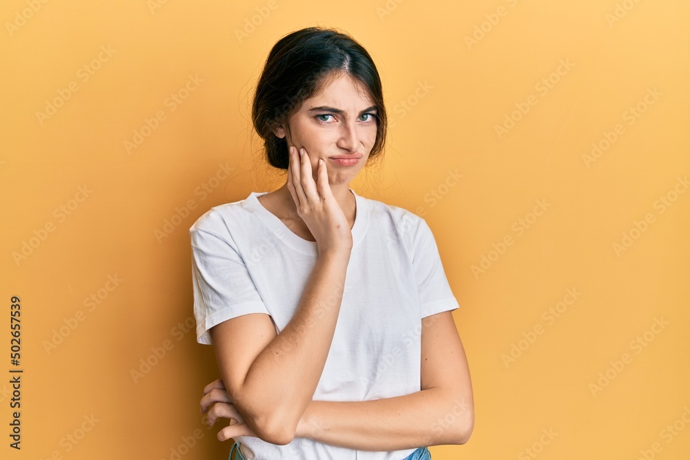 Young caucasian woman wearing casual white t shirt thinking looking tired and bored with depression problems with crossed arms. Young caucasian woman wearing casual white t shirt thinking looking tired and bored with depression problems with crossed arms.