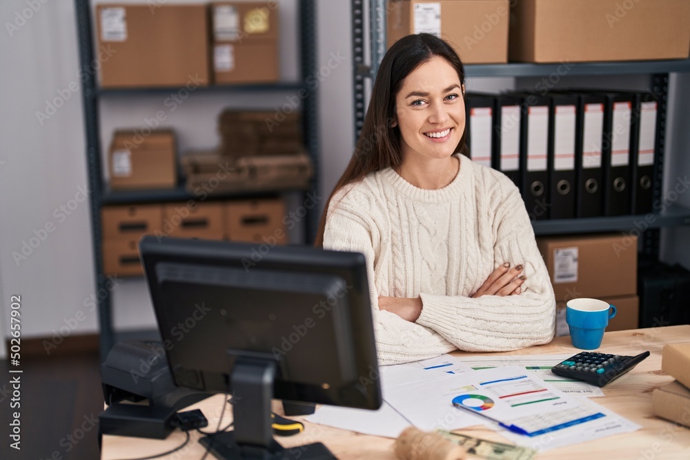 Young woman ecommerce business worker with arms crossed gesture at office