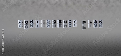 Photos contingency plan word or concept represented by black and white letter cubes on