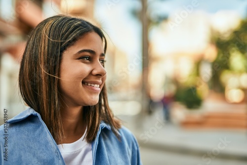 Young latin girl smiling happy standing at the city. Free Download Young latin girl smiling happy standing at the city. - GFXLoad
