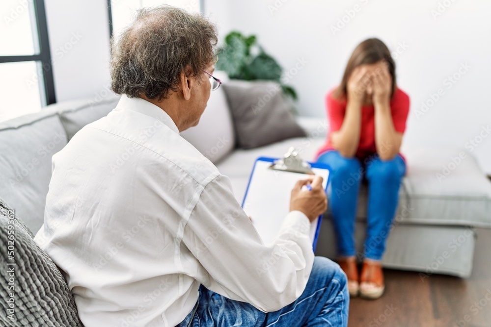 Middle age man and woman having psychology session at home Middle age man and woman having psychology session at home