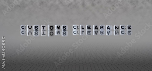 customs clearance word or concept represented by black and white letter cubes on a grey horizon background stretching to infinity