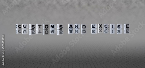 customs and excise word or concept represented by black and white letter cubes on a grey horizon background stretching to infinity