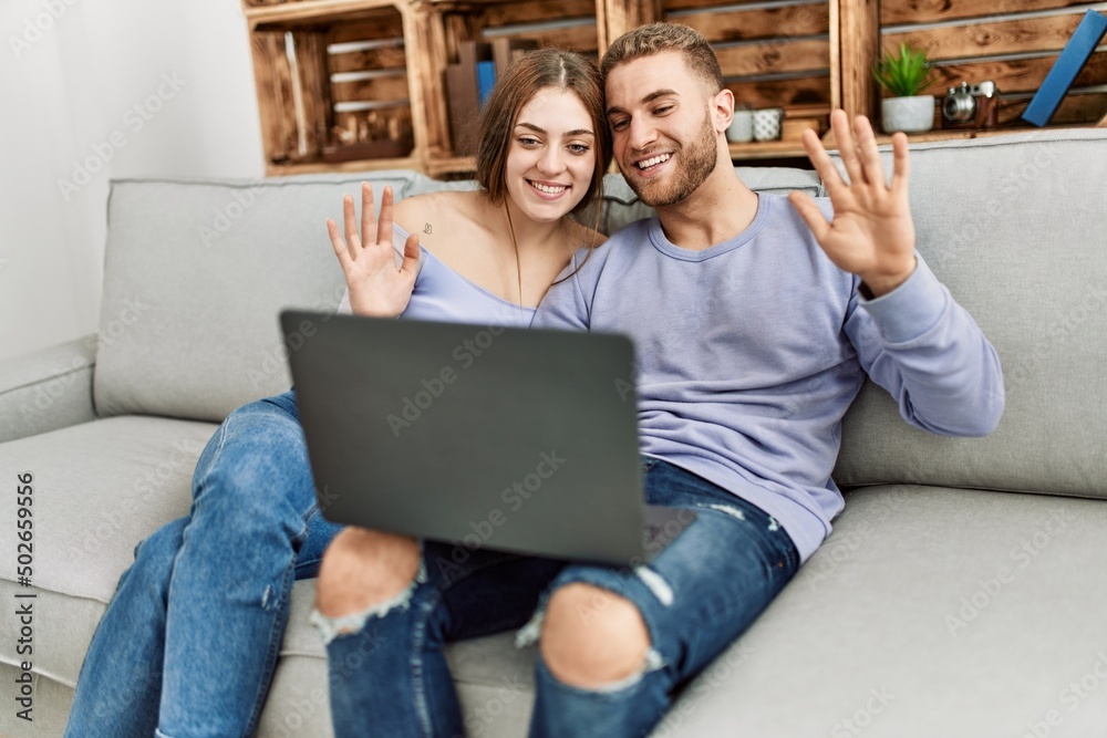 Young caucasian couple having video call using laptop at home. Young caucasian couple having video call using laptop at home.