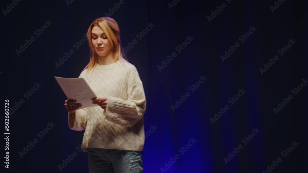 Talent contest. Woman reading jokes on stage. Female comedian speaking with audience, humorous monologue. 