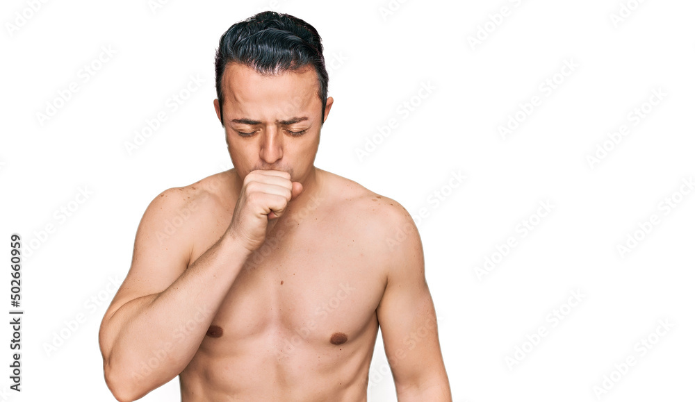 Handsome young man wearing swimwear shirtless feeling unwell and coughing as symptom for cold or bronchitis. health care concept.