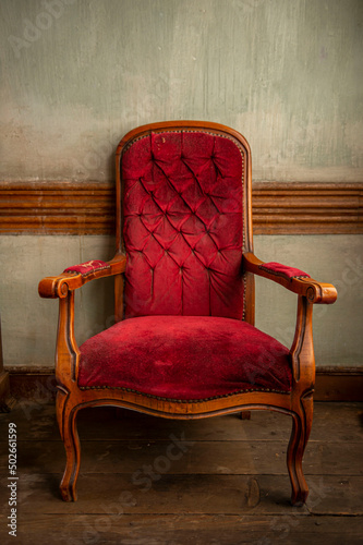 Vintage classic Luxury red armchair and on a wooden floor a green background